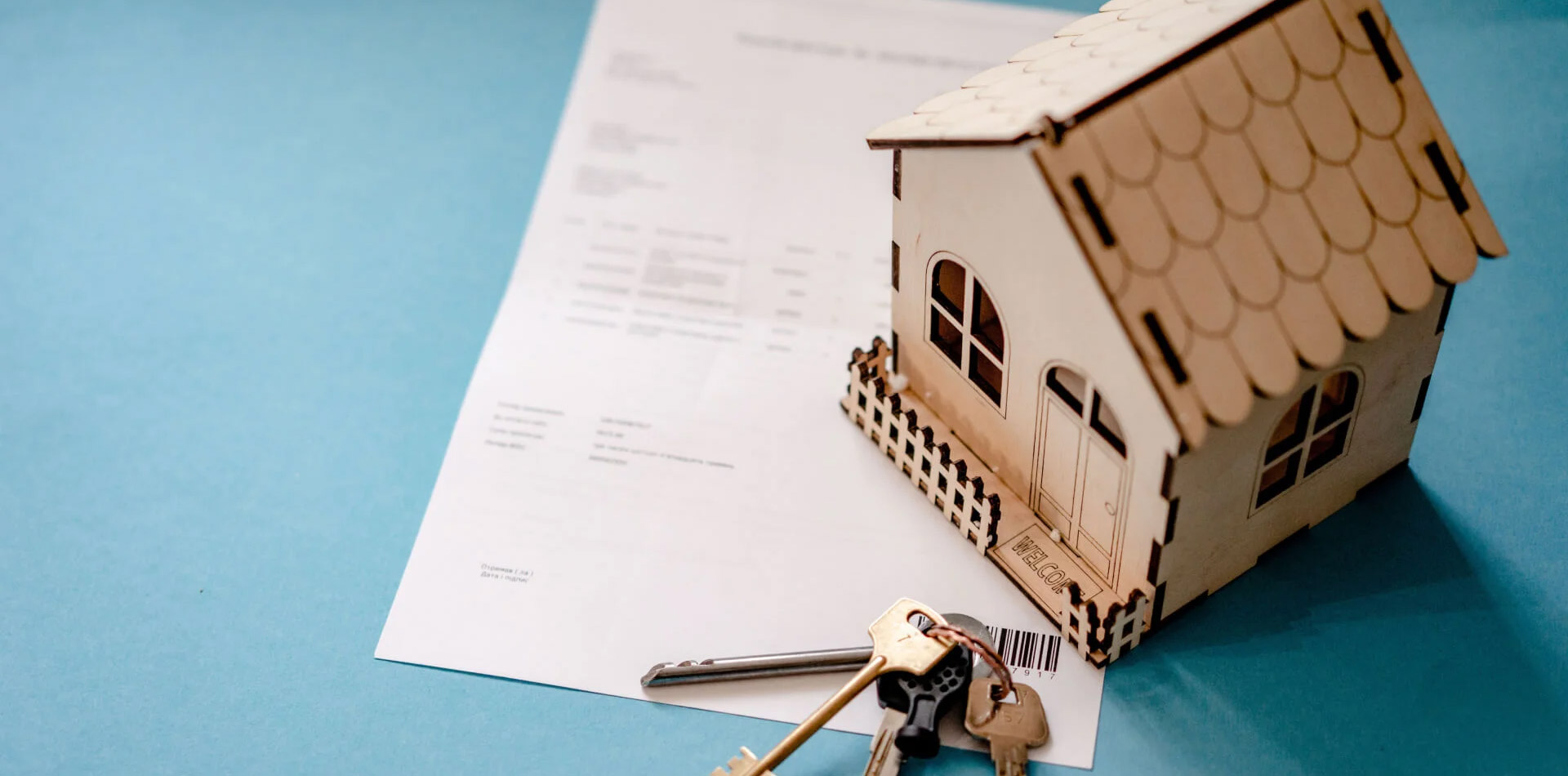 A house model, keys on a piece of a legal document